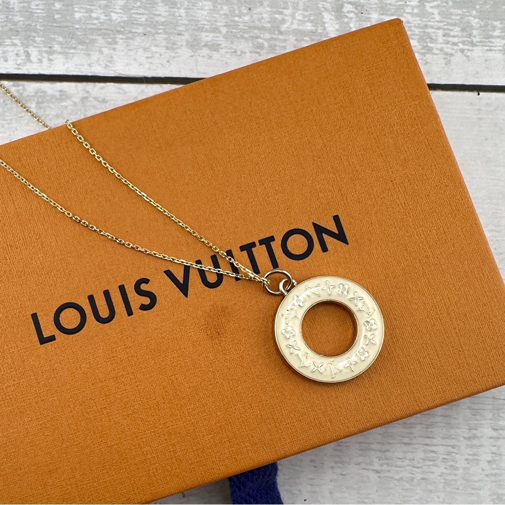 Authentic Louis Vuitton charm necklace with 18” gold chain.
